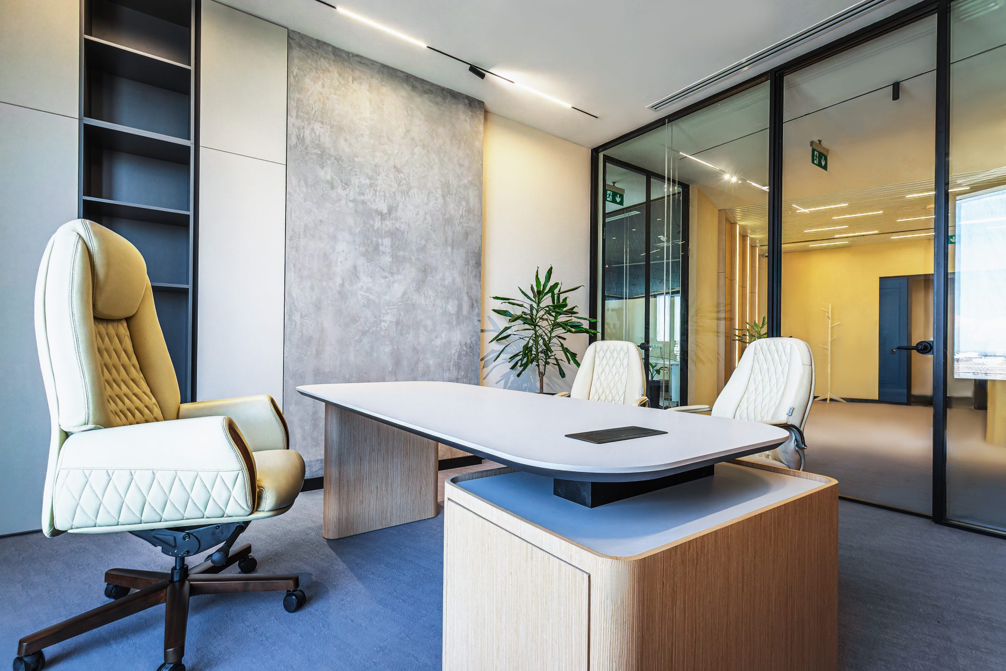 An open office floor with long desks where dozens of people work at laptops.